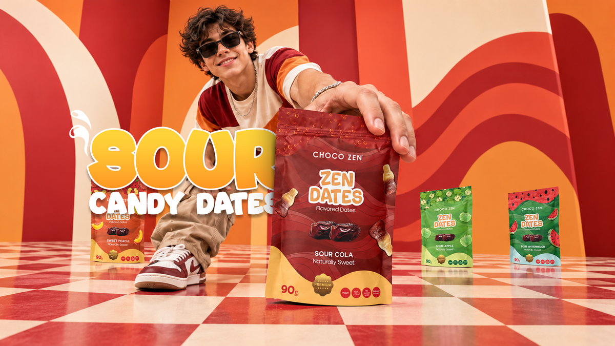 A person in sunglasses and a striped shirt holds up a bag of Choco Zen Zen Dates Sour Cola candy dates, with two other flavor bags standing in the background against a retro orange and white wavy wall and checkered floor.